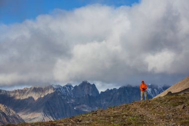 Hiker in beautiful mountains in Tombstone Territorial Park, Yukon, Canada