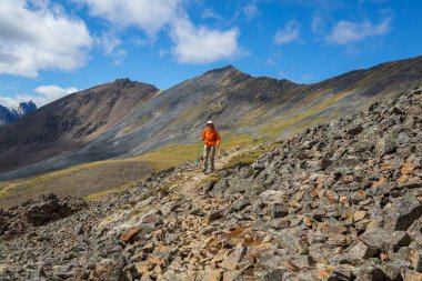 Hiker in beautiful mountains in Tombstone Territorial Park, Yukon, Canada