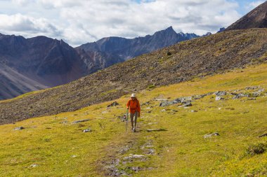 Hiker in beautiful mountains in Tombstone Territorial Park, Yukon, Canada