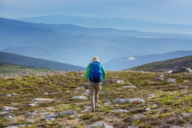 Hiker in beautiful mountains in Tombstone Territorial Park, Yukon, Canada