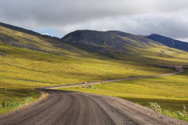 Sonsuz Dempster karayolu yakınındaki Kuzey Kutup dairesi, Dawson City Inuvik, Kanada için önde gelen uzak çakıl yol