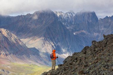 Hiker in beautiful mountains in Tombstone Territorial Park, Yukon, Canada