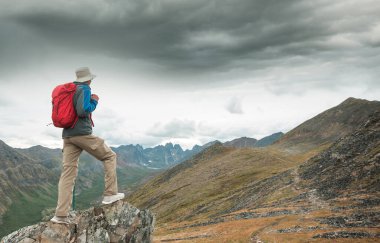 Hiker in beautiful mountains in Tombstone Territorial Park, Yukon, Canada
