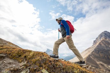hiker in mountains on beautiful rock background