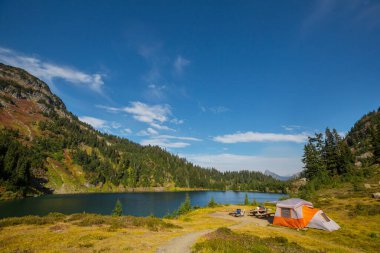 Hiking tent and backpacks in camping  in the mountains in summer season