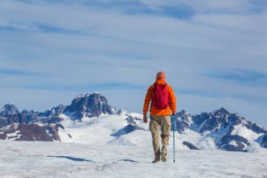 The climb in snowy mountains in the summer season