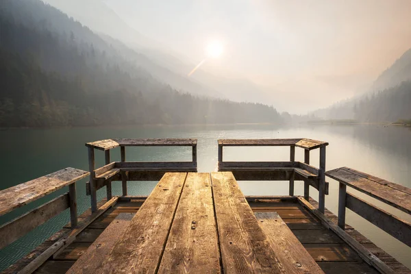 Wooden pier in serenity mountains lake