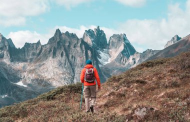 Hiker in beautiful mountains in Tombstone Territorial Park, Yukon, Canada