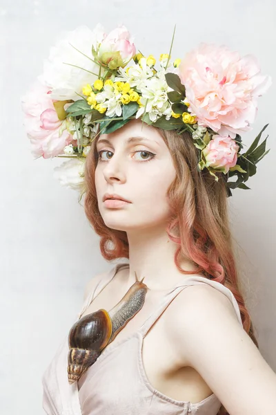 Calm pretty girl with snail and flower crown on head — Stock Photo, Image