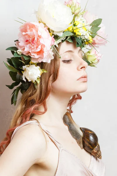 Calm pretty girl with snail and flower crown on head — Stock Photo, Image