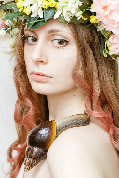 Calm pretty girl with snail and flower crown on head — Stock Photo, Image
