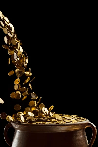 Gold coins falling in the vintage pot — Stock Photo, Image