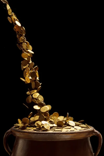 Gold coins falling in the vintage pot — Stock Photo, Image