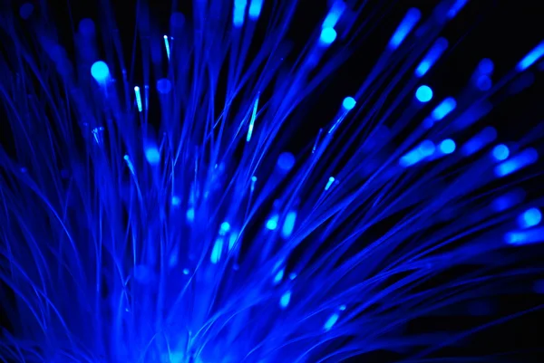 The blue optical fibers with black background. — Stock Photo, Image