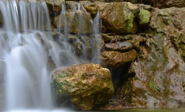 Long exposure of beautiful waterfalls and stream in the amidst lush vegetation. — Stock Photo, Image