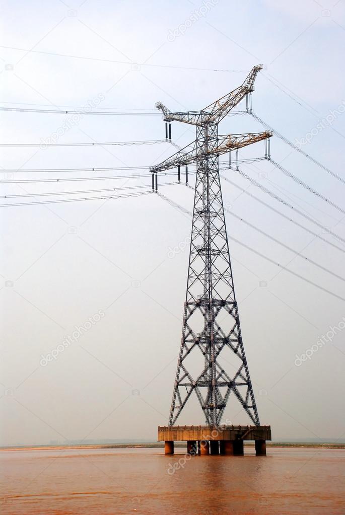 Electricity pylon iron grid with power lines.