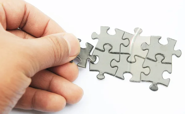 Hands with two puzzles — Stock Photo, Image