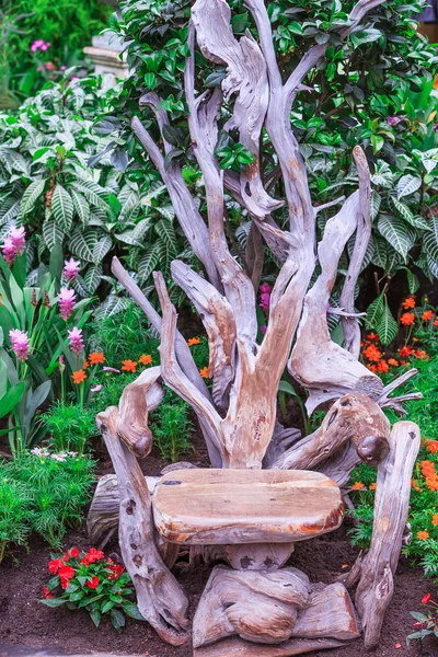 Un trono hecho de madera de deriva para uso público en un jardín de flores —  Fotos de Stock