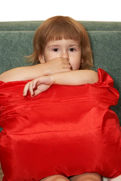 The small girl with a red pillow Royalty Free Stock Photos