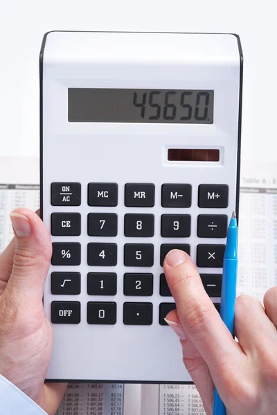 The businessman and calculator Royalty Free Stock Images