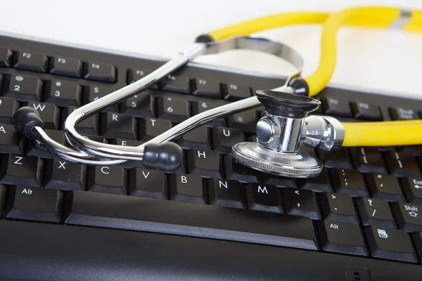 Phonendoscope and black keyboard — Stock Photo, Image