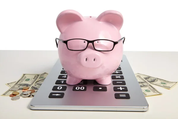 Pig bank on calculator — Stock Photo, Image