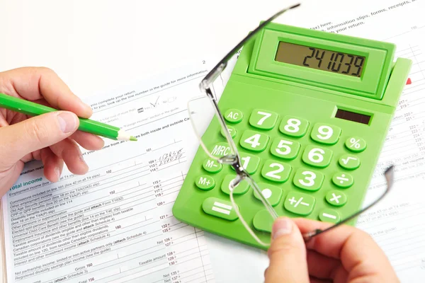 The businessman and green calculator Stock Photo
