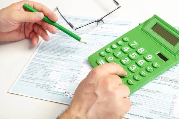 The businessman and green calculator Stock Image