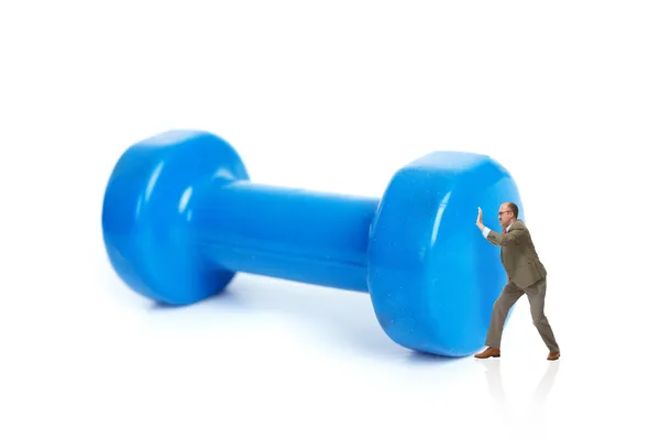 Businessman and blue dumbbells — Stock Photo, Image