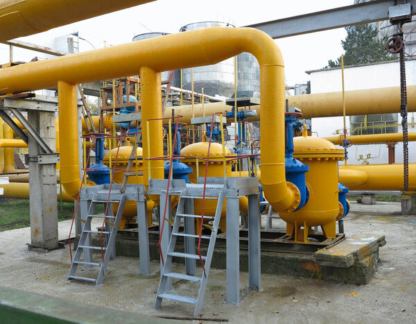 Natural gas station with yellow pipes power plant