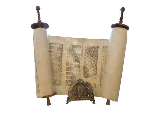 The Jewish Torah scroll and a gold menorah candle support isolat