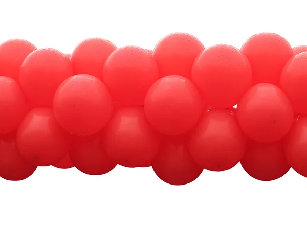 Куча красных шариков на белом фоне — стоковое фото