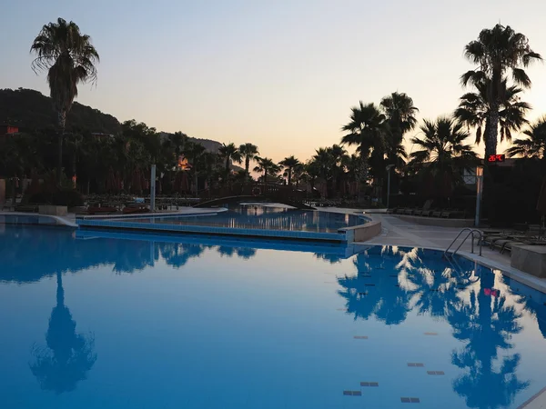 Роскошный бассейн и пальмы в фешенебельном отеле — стоковое фото