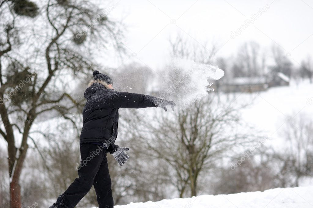 boy throwing snowballs