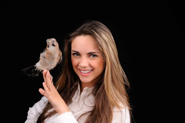 Portrait of smiling girl with bird on the hand — Stock Photo, Image