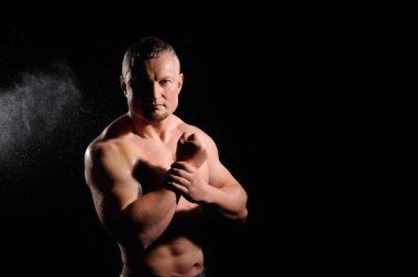 kaslı erkek siyah arka plan üzerine poz