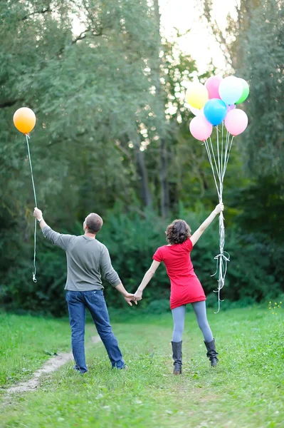 Happy future parents on the walk in summer park — Stock Photo, Image