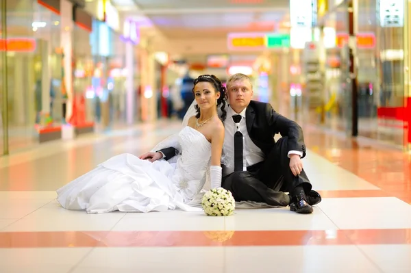Nevěsta a ženich sedí na podlaze — Stock fotografie