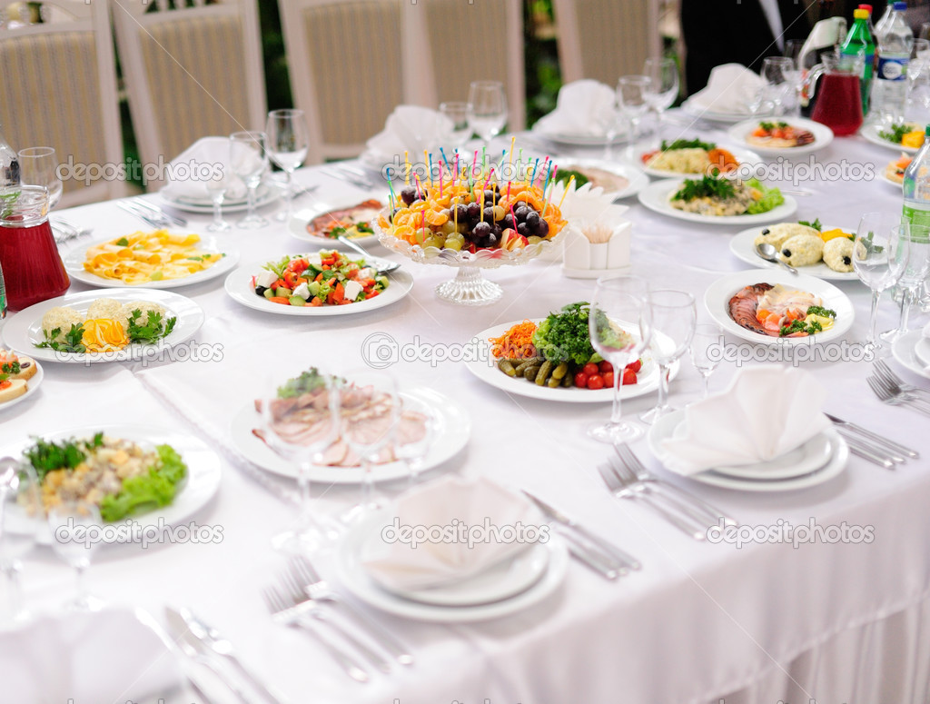 table set service with silverware and glass stemware at restaurant before party 
