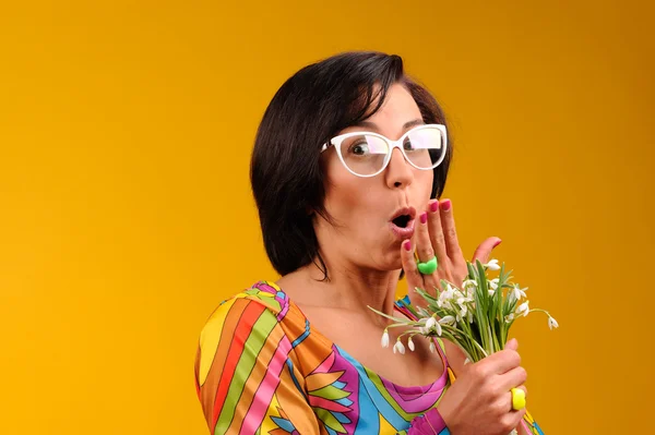 Pretty girl in glasses and snowdrops with funny emotions — Stock Photo, Image