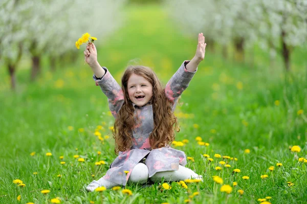 Pequena menina bonita no jardim verde — Fotografia de Stock