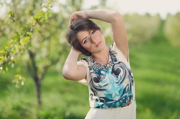 Girl in the blooming garden — Stock Photo, Image