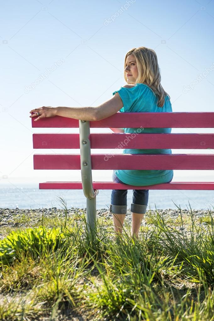 Pretty woman on pink bench