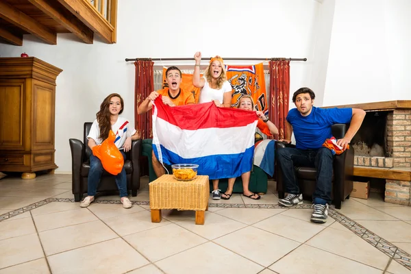 Soccer Fans Cheering While Watching Match At Home Stock Photo