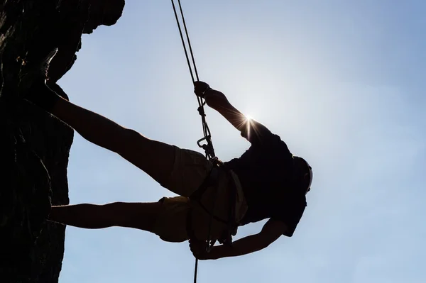 Silhouetted Man Climbing Rock — Stock Photo, Image