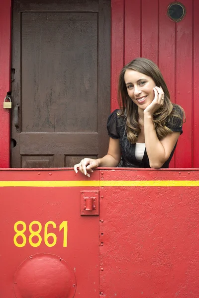 Woman Leaning On Railing In Red Train Caboose Car — Stock Photo, Image