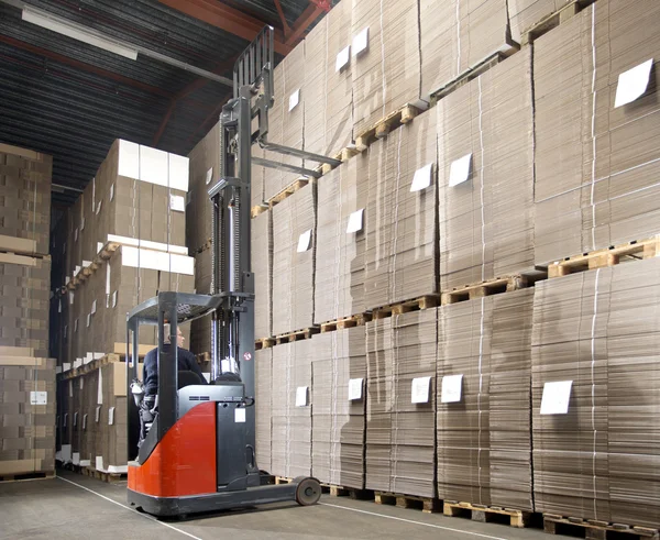 Forklift lifting from top shelf — Stock Photo, Image