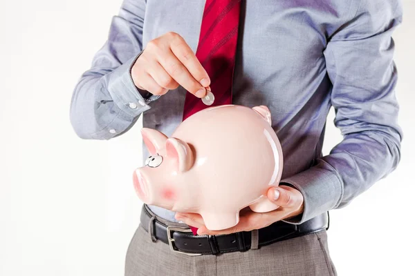 Affärsman som innehar en gris bank - ekonomin besparingar — Stockfoto