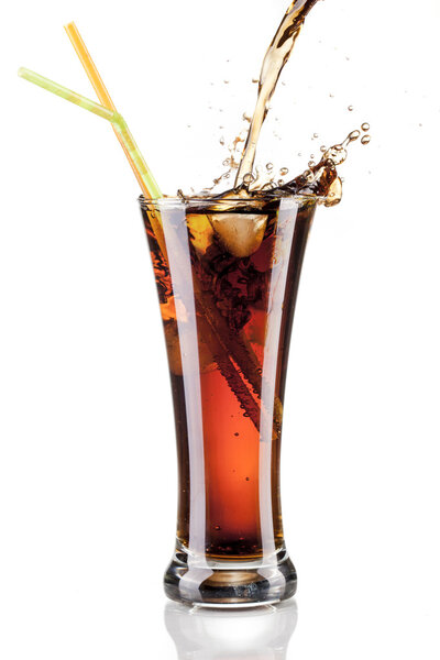 Fresh cola juice and ice cubes splash in a glass on white background