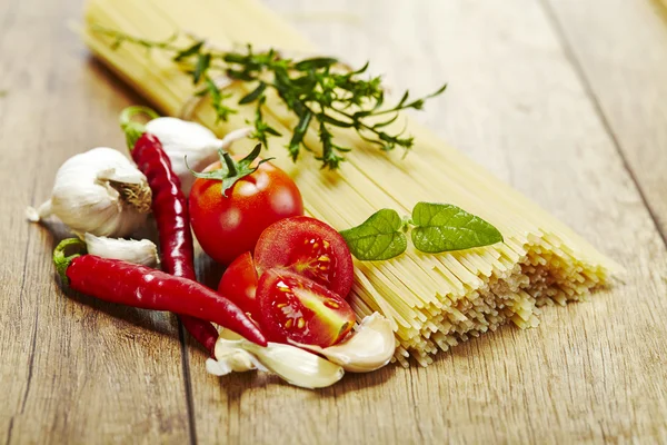 Italian pasta on wooden background — Stock Photo, Image